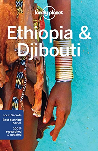 "Travel guide book cover featuring a woman's hand adorned with colorful bracelets against a blue background."