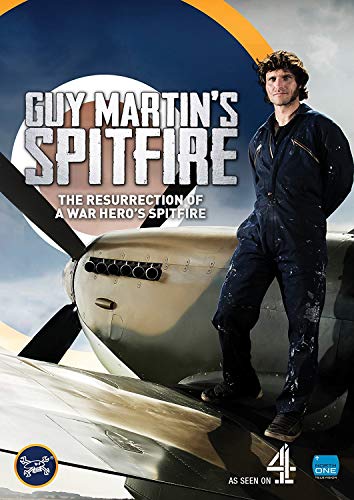 Guy Martin standing on the wing of a Spitfire aircraft.