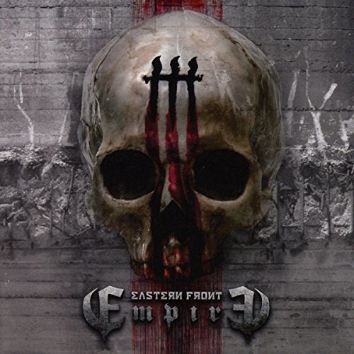 A skull with a pitchfork on its forehead, against a grey brick wall background.