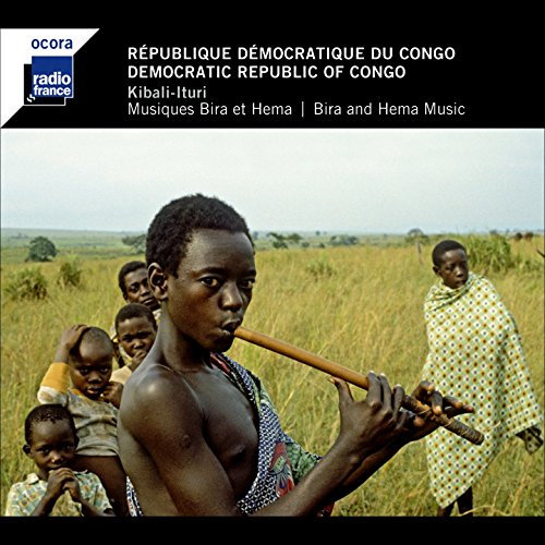 CD cover: young man playing a flute in a grassy field, Congo.