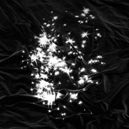 Black fabric with a burst of bright, sparkling light effects.