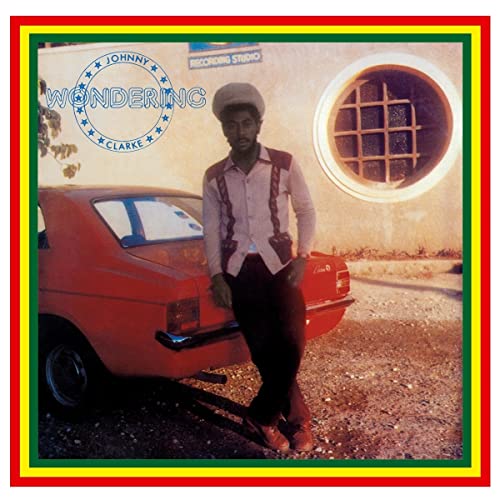 Johnny Clarke album cover: man leaning on a red car, recording studio.