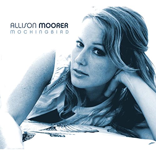 "CD cover with blue-toned image of woman resting on her elbow, looking left."