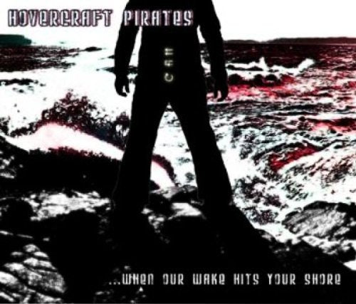 CD cover: Silhouette of a person standing on rocks by the sea.
