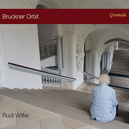 CD cover: man seated on stairs in a stone hallway.