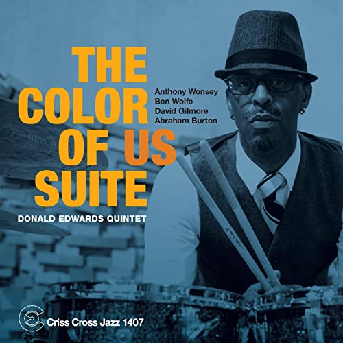 CD cover featuring a drummer in a hat and glasses, blue tone.
