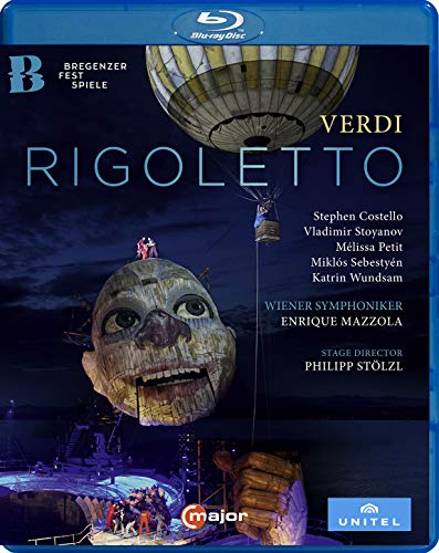 Blu-ray cover for Verdi’s “Rigoletto” opera featuring a large puppet face.