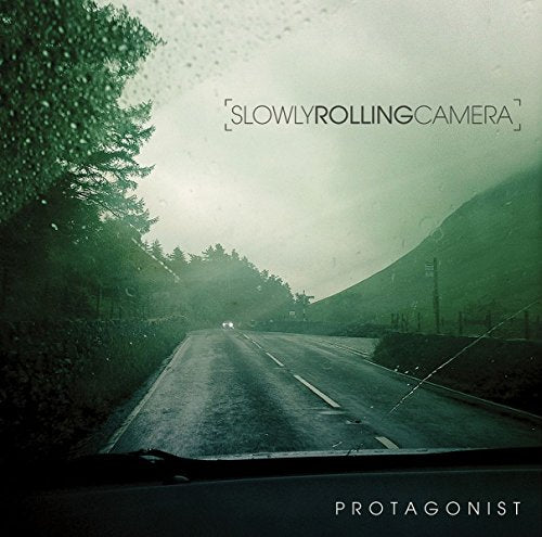 Vinyl record cover with a rainy road scene viewed through a windshield.