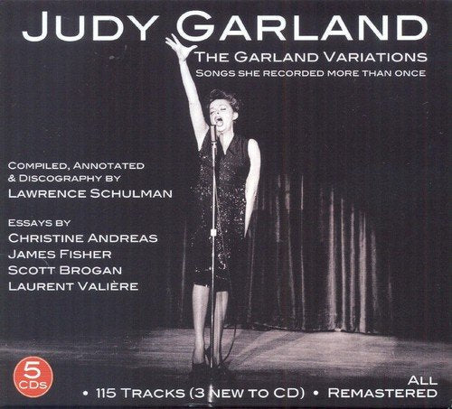 Black and white image of Judy Garland singing into a microphone on stage.