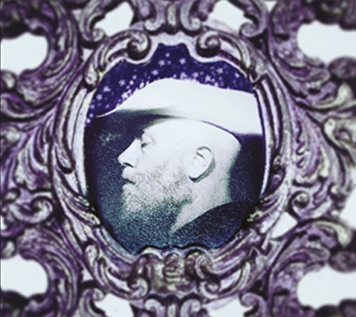 Close-up of a bearded man’s profile within an ornate, purple frame.