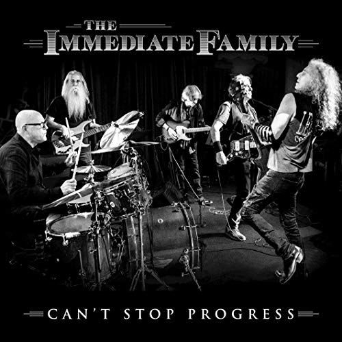 Black and white photo of five musicians playing instruments onstage.