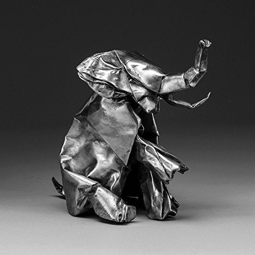 Black and white photo of an origami elephant sculpture.