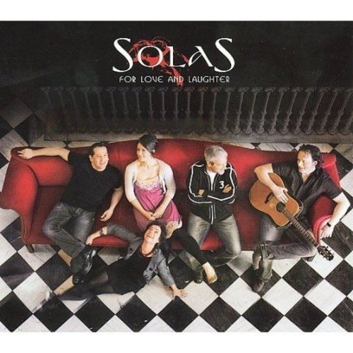 "CD cover featuring four people on a red couch on a checkered floor."
