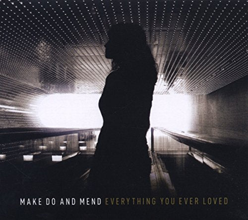 A CD cover featuring a silhouette of a woman in a tunnel with lights.