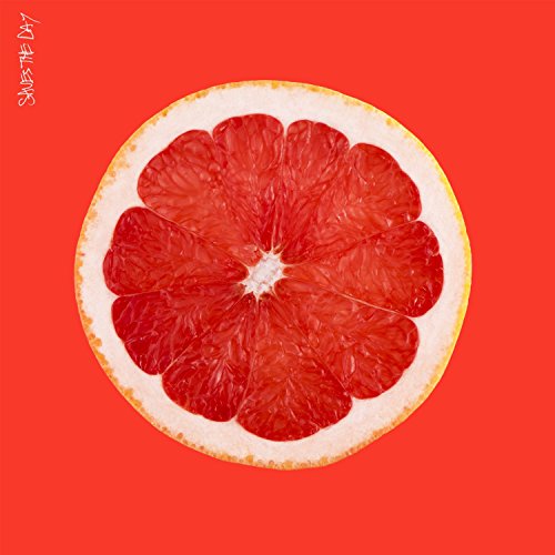 A halved grapefruit with red flesh on a red background, with the band name written vertically.