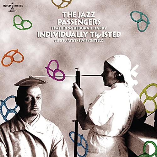 Album cover: two people in lab coats with colorful, abstract shapes.