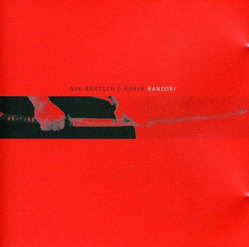 Red album cover with black abstract image of hands and a sword.