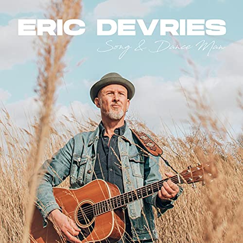 CD cover featuring Eric De Vries with a guitar in a field.