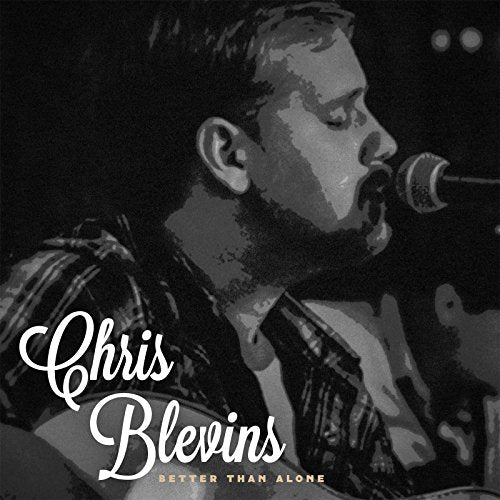 Black and white portrait of Chris Blevins singing into a microphone.