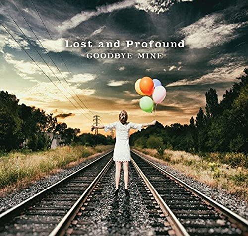 Girl with balloons stands on railroad tracks under a cloudy sky.