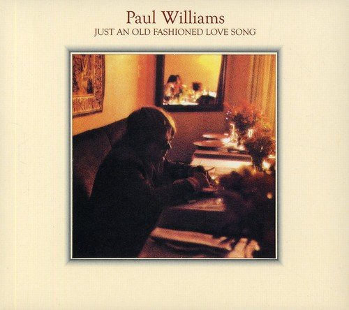 Album cover with a person sitting alone at a candlelit dinner table indoors.