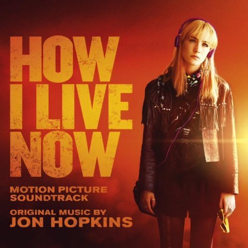 "Album cover with a blonde woman wearing headphones on a red background."