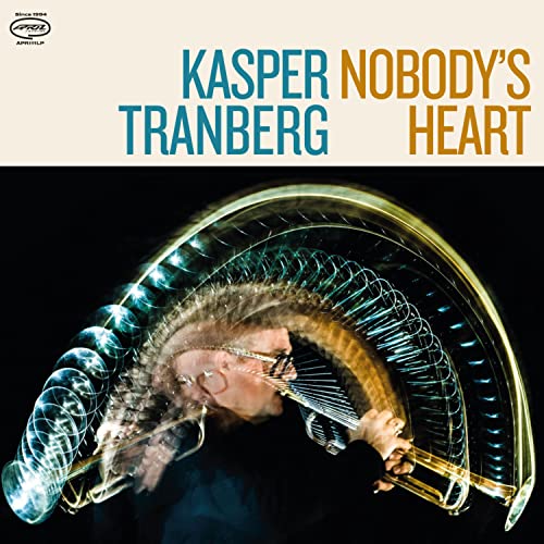 CD cover: Kasper Tranberg with trombone and light streaks.