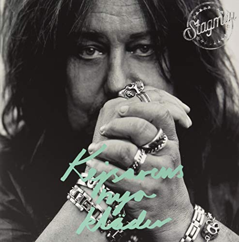 Black and white portrait of a man with long hair and rings on his hand.