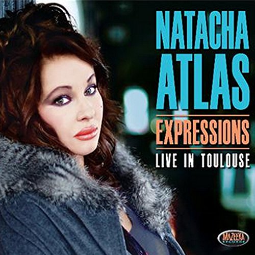 "CD cover featuring Natacha Atlas, a woman with brown hair, wearing a grey fur coat."
