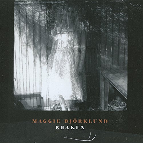 "CD cover with a black-and-white image of a dress in a cage."