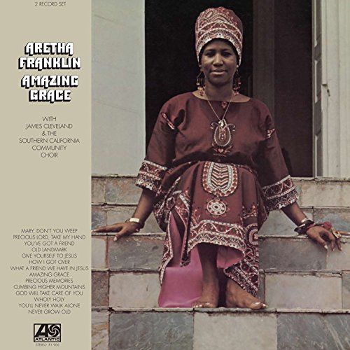 "Aretha Franklin sitting on steps, wearing maroon dress and headwrap, on album cover."