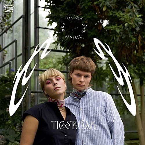 CD cover with two people in front of greenery and abstract white shapes.