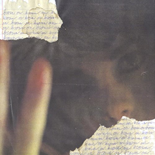 Close-up of a face partially obscured by paper with handwritten text.