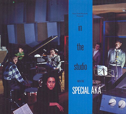 "Album cover featuring a band in a recording studio with a blue banner."