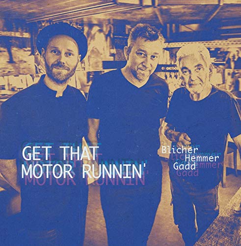 "Album cover featuring three men in black shirts, blue-toned image with text overlay."