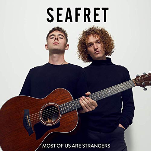 "Album cover featuring two men, one holding a guitar, against a white background."