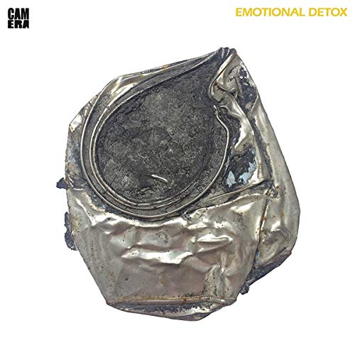 Crushed silver tin can with dirt inside on a white album cover.