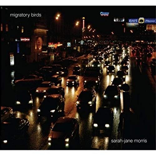 CD cover: Night city street scene with traffic, album title visible.