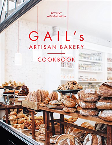 "Cookbook cover featuring a bakery display with various breads and pastries."