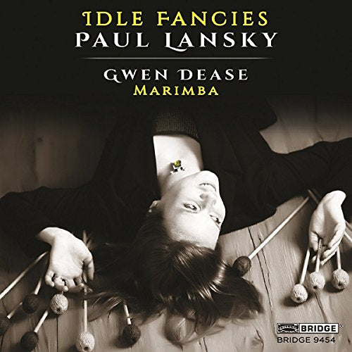 "CD cover featuring a woman lying on the floor with marimba mallets around her."