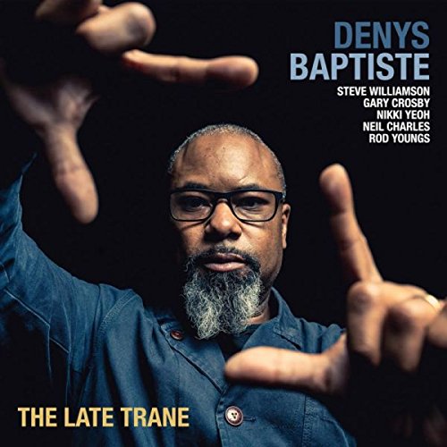 Man with glasses and beard gestures towards camera on dark blue album cover.