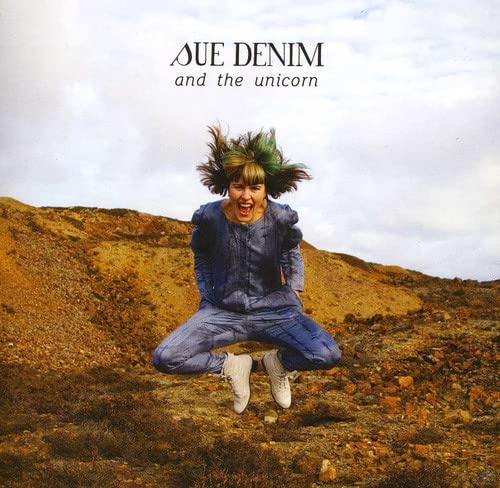 Album cover: person jumping in front of a brown hillside.
