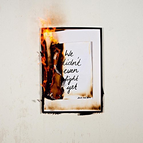 Burning paper with handwritten text, album artwork for "We Did Not Even Fight Yet.