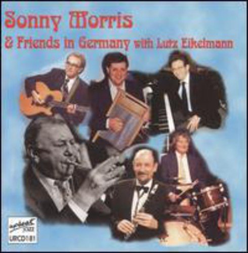 CD album cover featuring six men playing various instruments against a blue background.