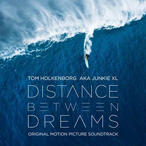 Album cover: surfer under a large wave, text “Distance Between Dreams”.