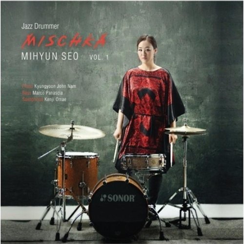 CD cover featuring a drummer with her drum kit against a grey background.