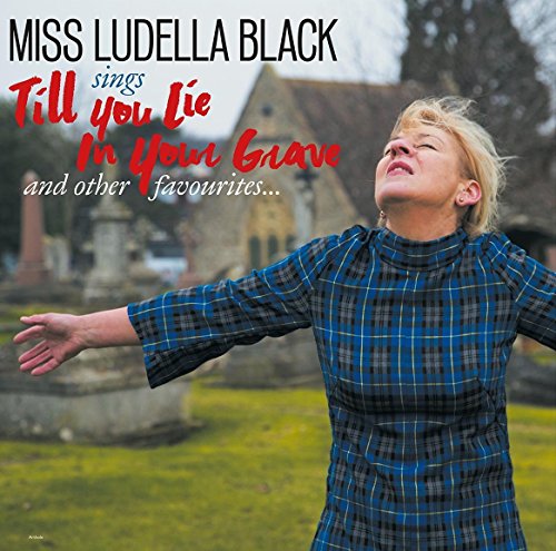 CD cover: woman with arms outstretched before a churchyard.