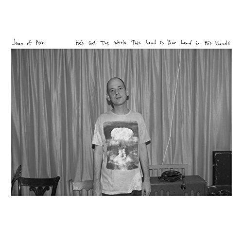 Black and white album cover featuring a man standing in front of curtains.