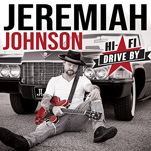 Jeremiah Johnson with guitar, posing by a classic car for album cover.