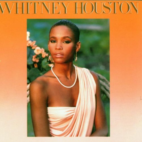 "Whitney Houston album cover with a portrait of Whitney Houston in a beige dress."